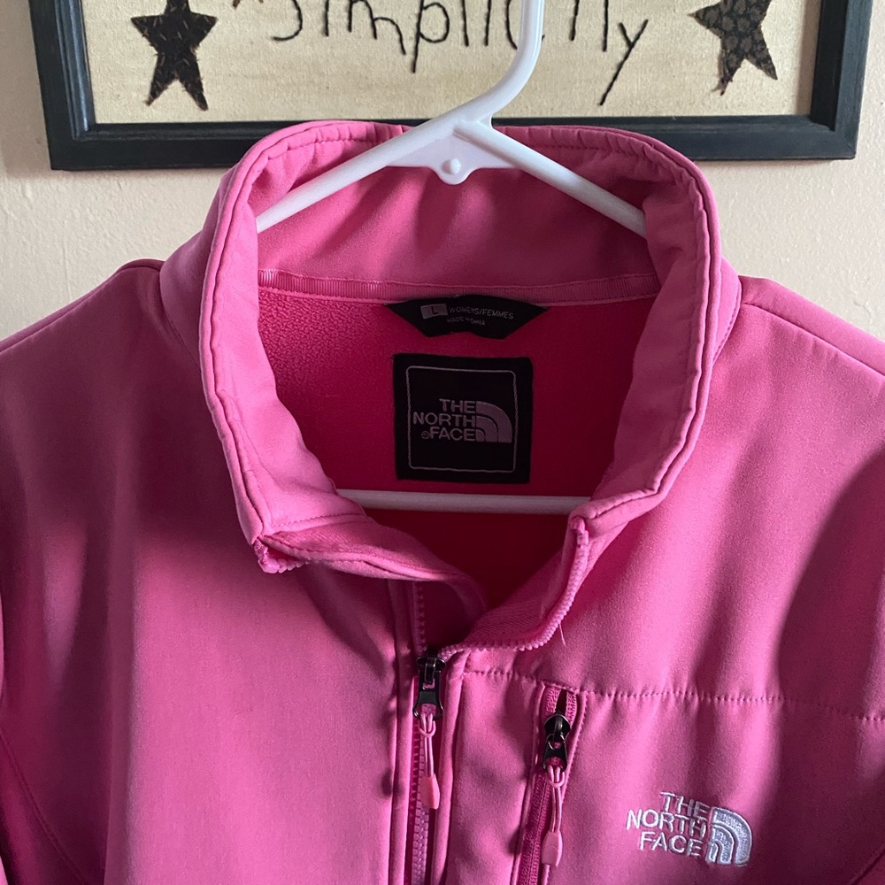 Woman’s pink Northface coat.